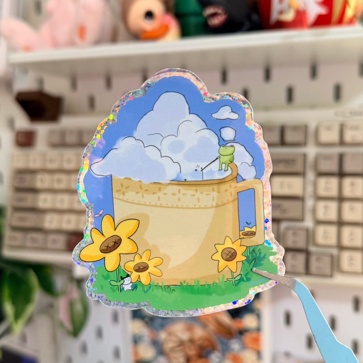 Coffee Time Glitter Sticker featuring yellow coffee mug filled with clouds and flowers.