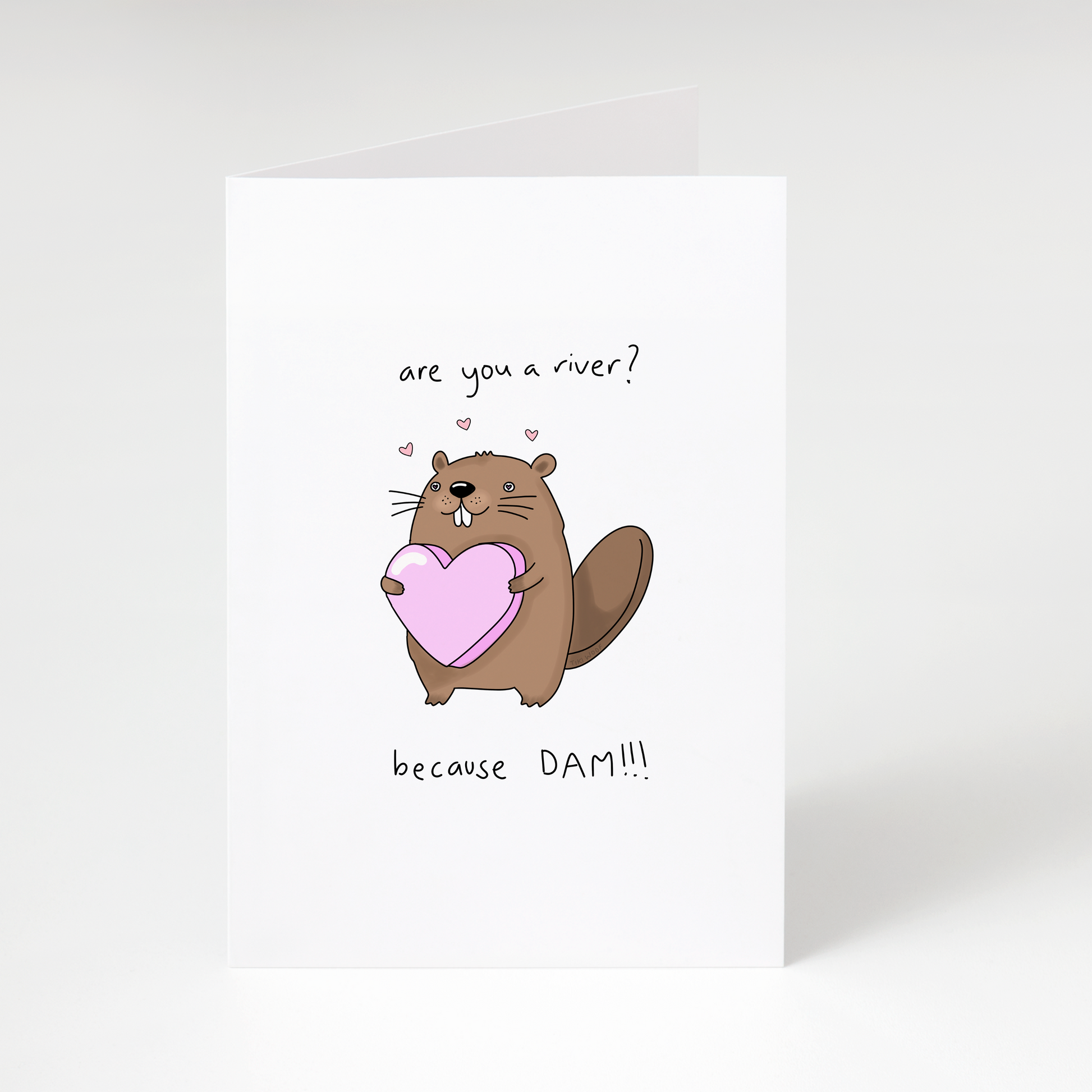 Cute beaver holding pink heart with text “Are you a river? Because DAM!!!” on white greeting card
