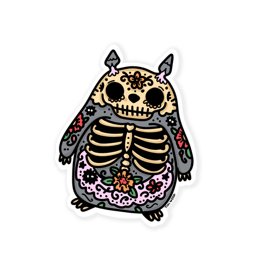 Totoro-inspired sticker with skeleton ribs and colorful floral sugar skull patterns, Day of the Dead themed vinyl sticker on white background.
