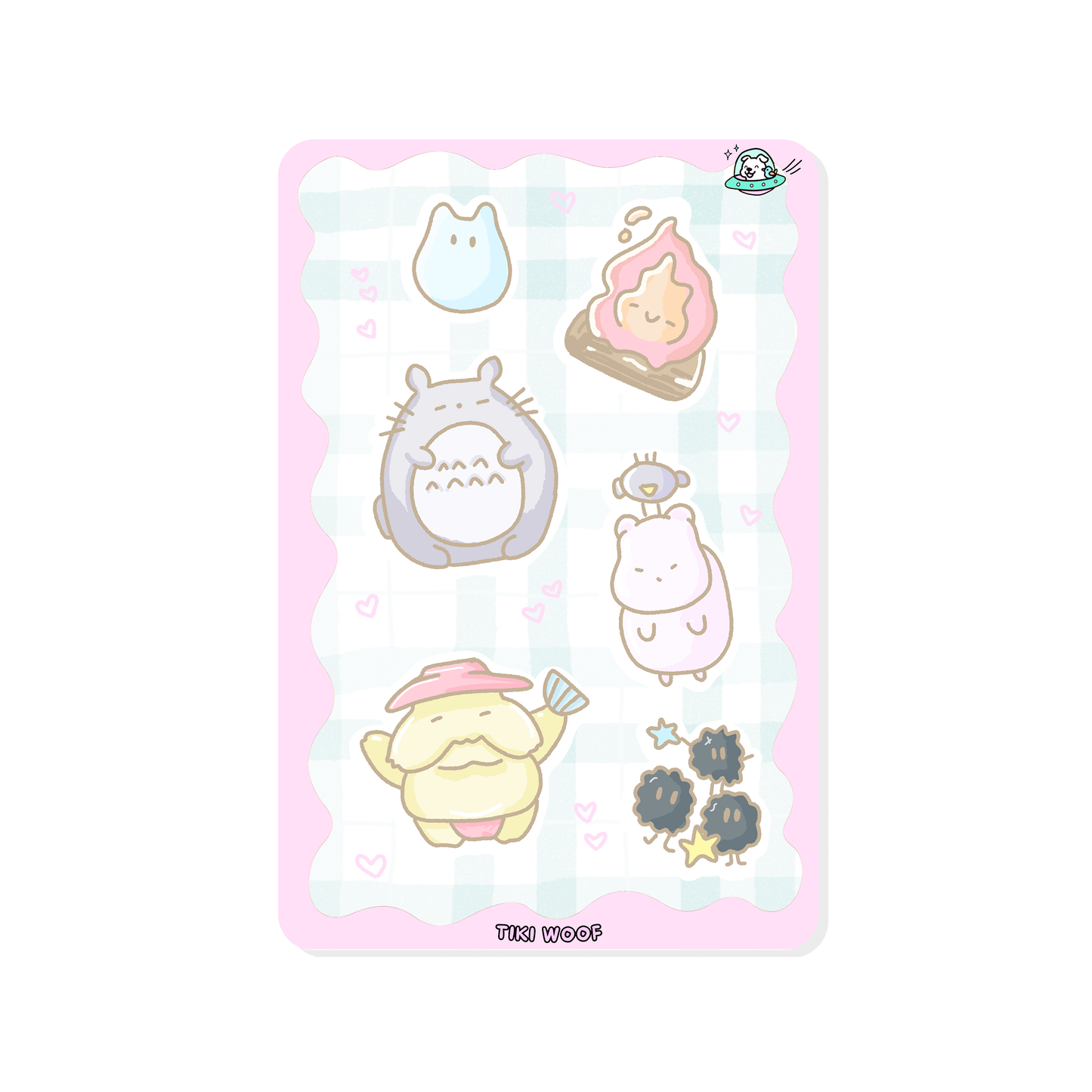 Mini sticker sheet featuring pastel Studio Ghibli inspired characters including Totoro, soot sprites, and other cute creatures on a soft pink checkered background.```