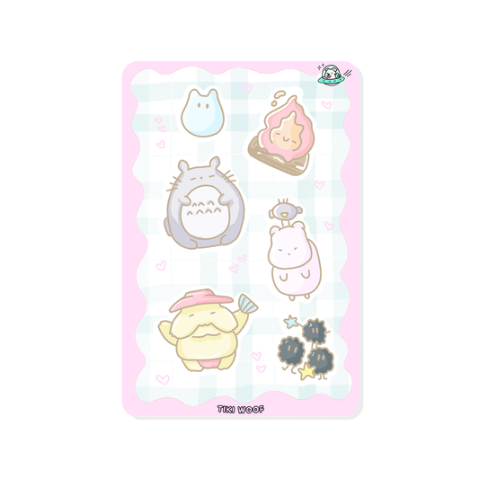Mini sticker sheet featuring pastel Studio Ghibli inspired characters including Totoro, soot sprites, and other cute creatures on a soft pink checkered background.```