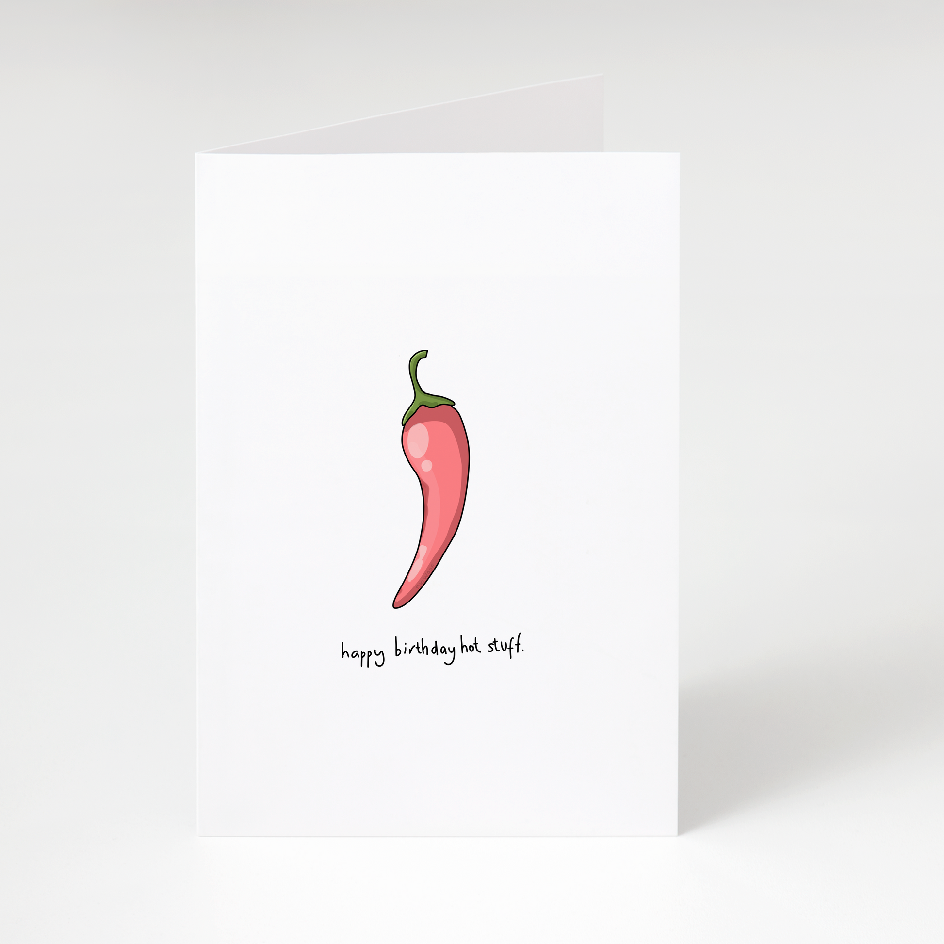Red chilli pepper illustration with text “happy birthday hot stuff” on white funny birthday greeting card
