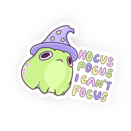 Kawaii green frog wearing a purple wizard hat with stars, next to colorful text that reads “Hocus Pocus I Can’t Focus,” cute pastel vinyl sticker on white background.
