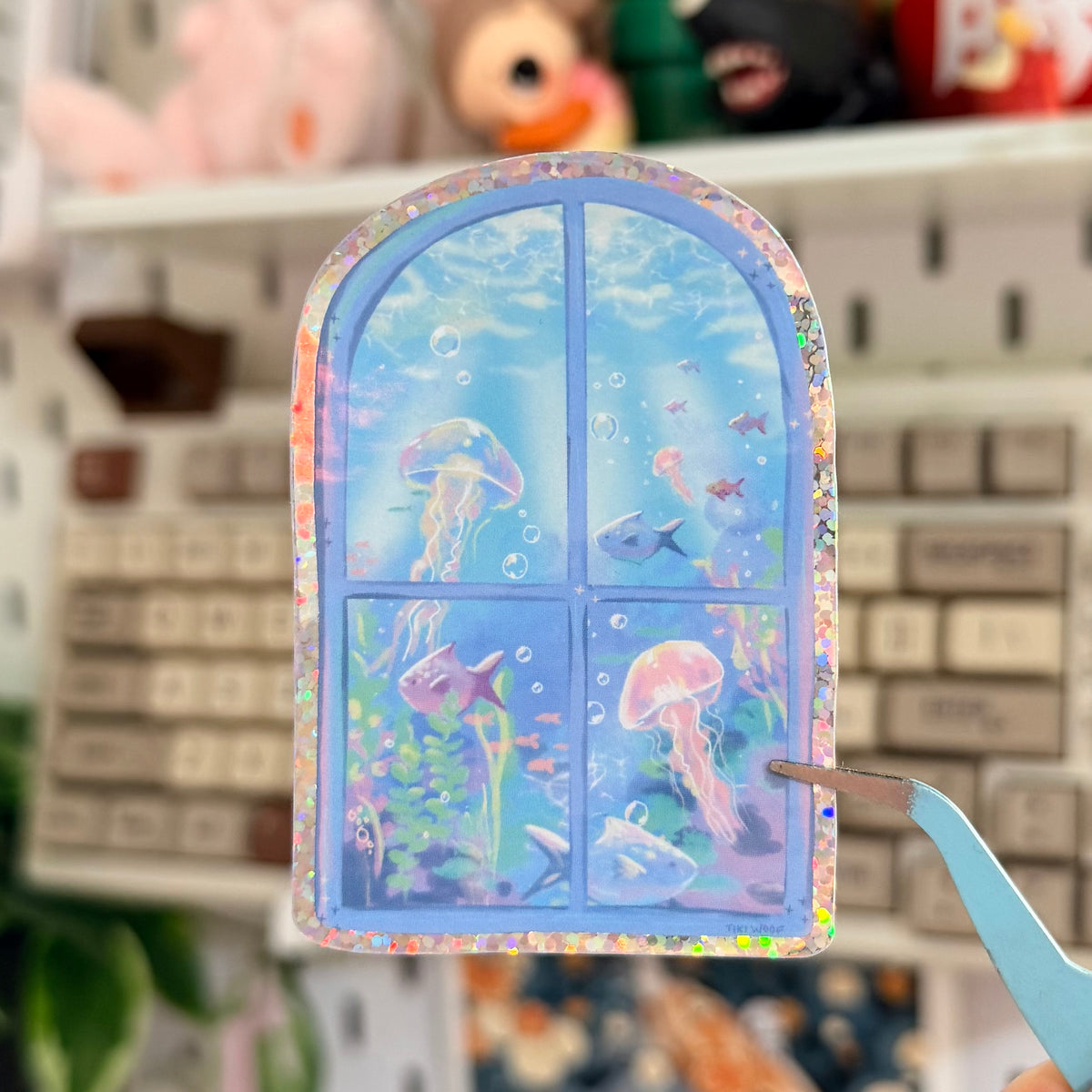 Underwater Window Glitter Sticker featuring pastel blue arched window looking into a dreamy underwater scene.