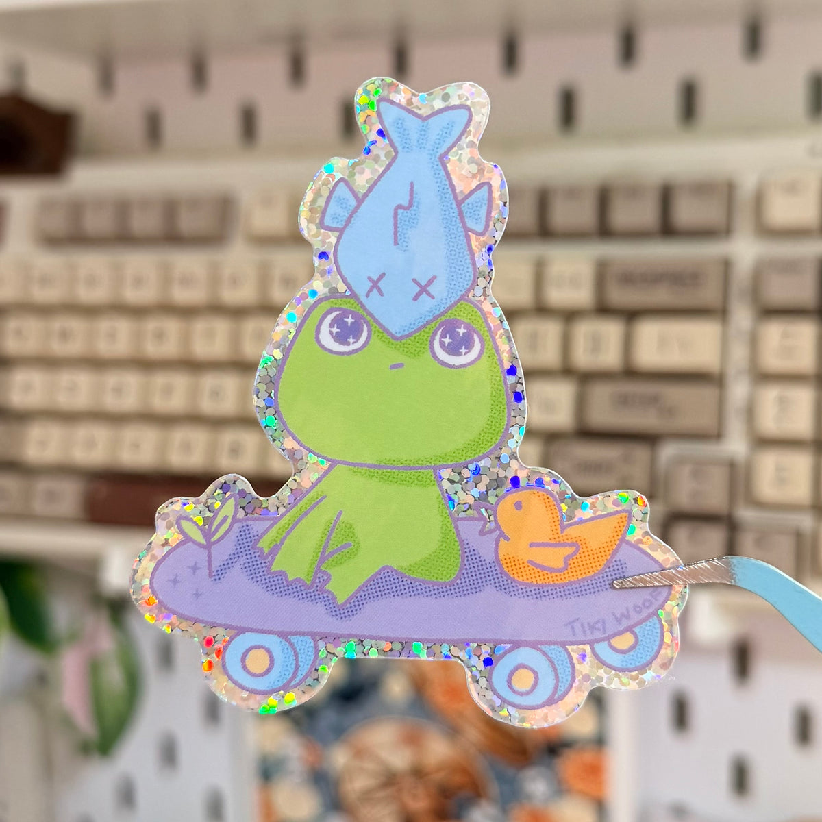 Go Weird or Go Home Glitter Sticker featuring pastel alien pouring a drink over a flying saucer.