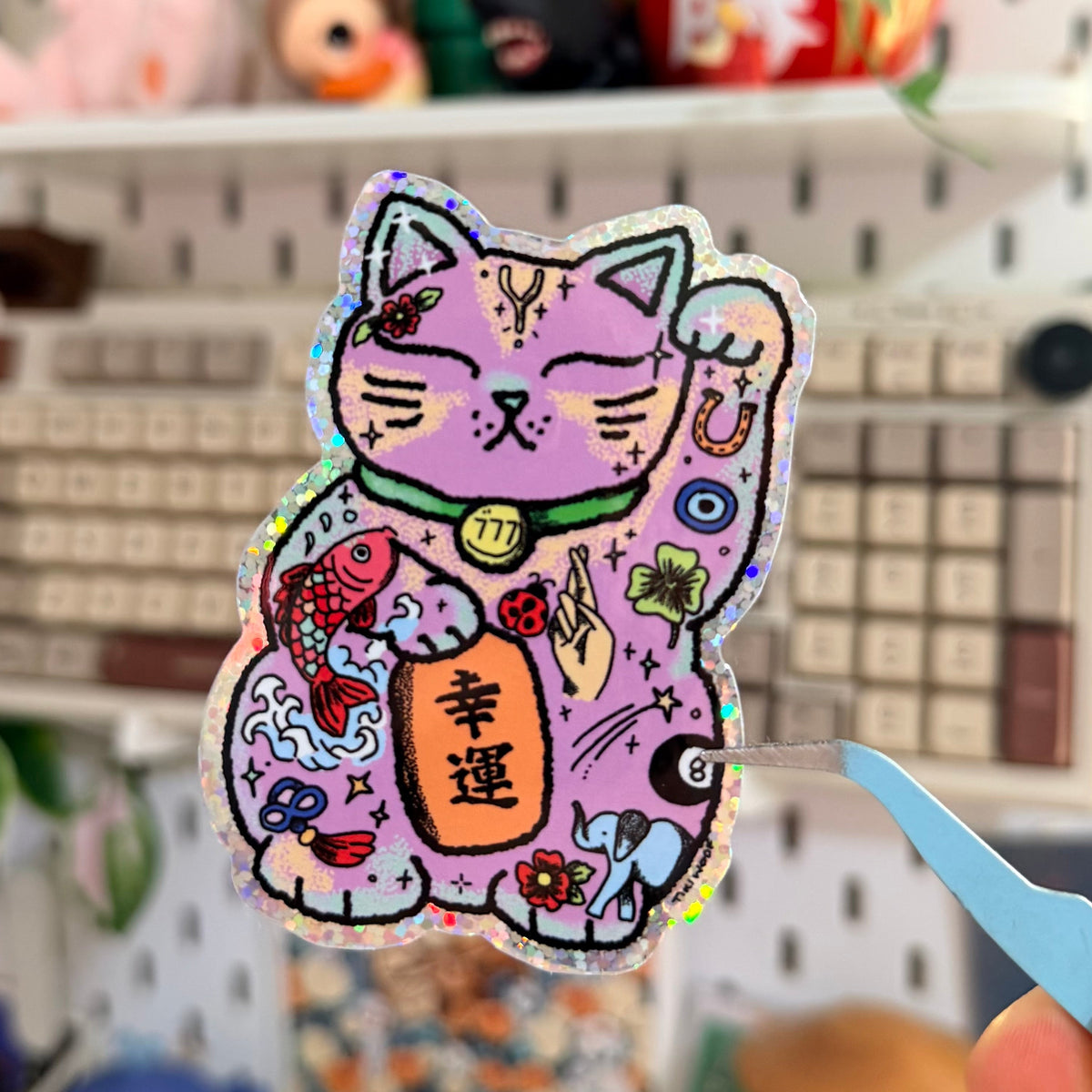 Lucky Cat Glitter Sticker featuring decorative pink and purple waving lucky cat.