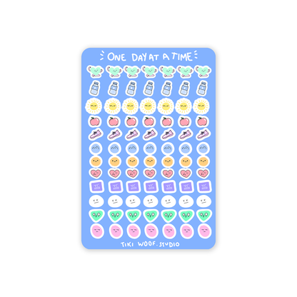 One Day at a Time journaling sticker sheet featuring pastel kawaii icons like water bottles, suns, fruits, hearts, and faces by Tiki Woof Studio on a blue background.