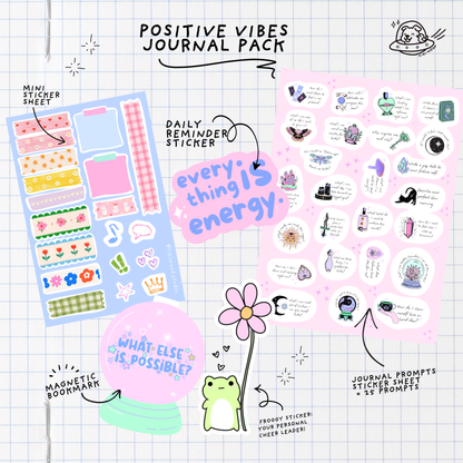 Flat lay of the Positive Vibes Journal Pack featuring a pastel mini sticker sheet, daily reminder sticker, magnetic bookmark, frog sticker, and journal prompt sheet on a grid paper background.```