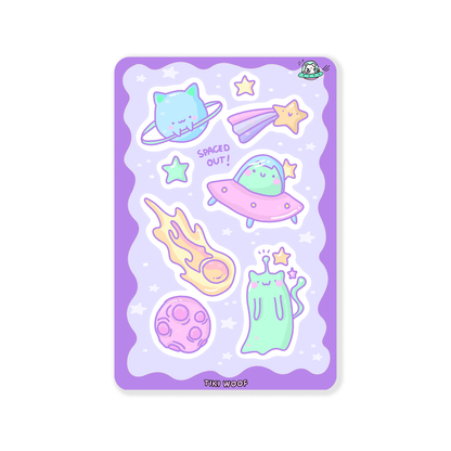 Sticker sheet featuring pastel space-themed designs with cute aliens, planets, comets, and stars on a lavender background.```
