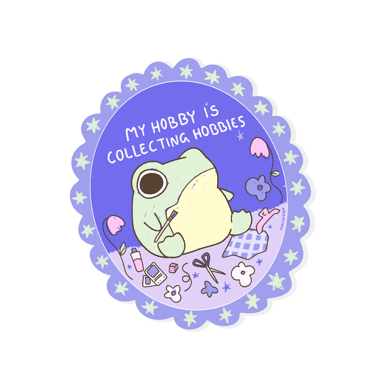 Cute frog vinyl sticker with the phrase "My Hobby Is Collecting Hobbies" surrounded by craft supplies, flowers and stationery on a purple background.