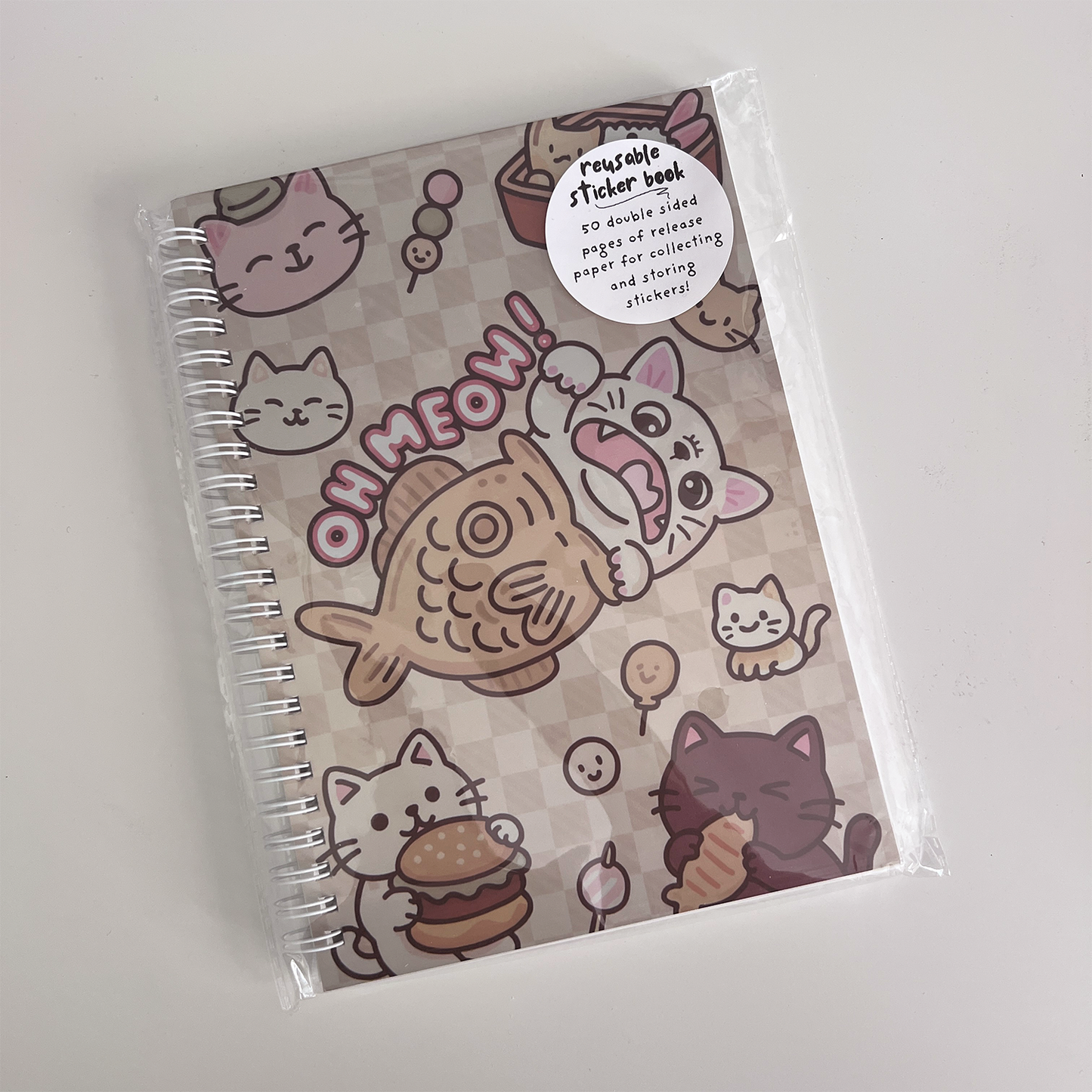 A5 reusable sticker collection book with spiral binding and 50 glossy release sheets for storing and reusing stickers.
